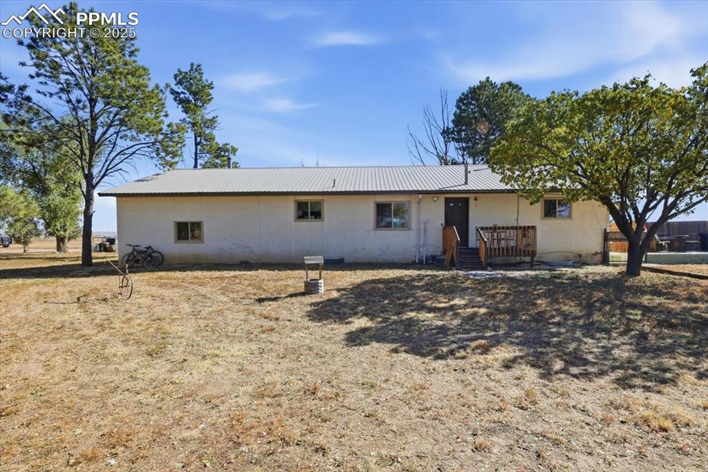 Image 23 of 49: Back of house featuring a deck