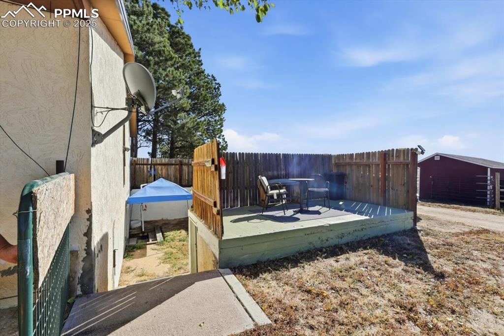 Image 24 of 49: private deck above the root cellar/storage room/storm shelter, and private