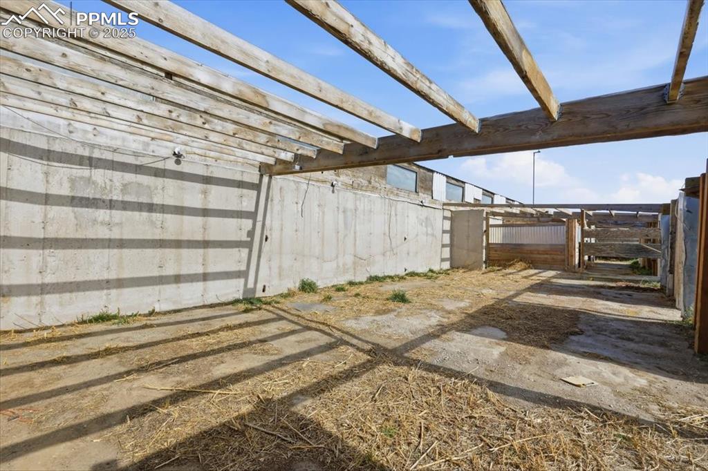 Image 39 of 49: Open area that could be used for hay storage. Roof is being replaced