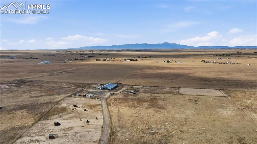 Image 45 of 49: There is an obstacle course and outdoor arena next to the barn.