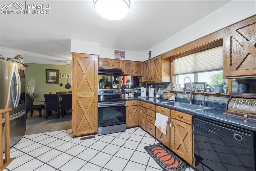 Image 5 of 49: Main level kitchen looking into the dining area