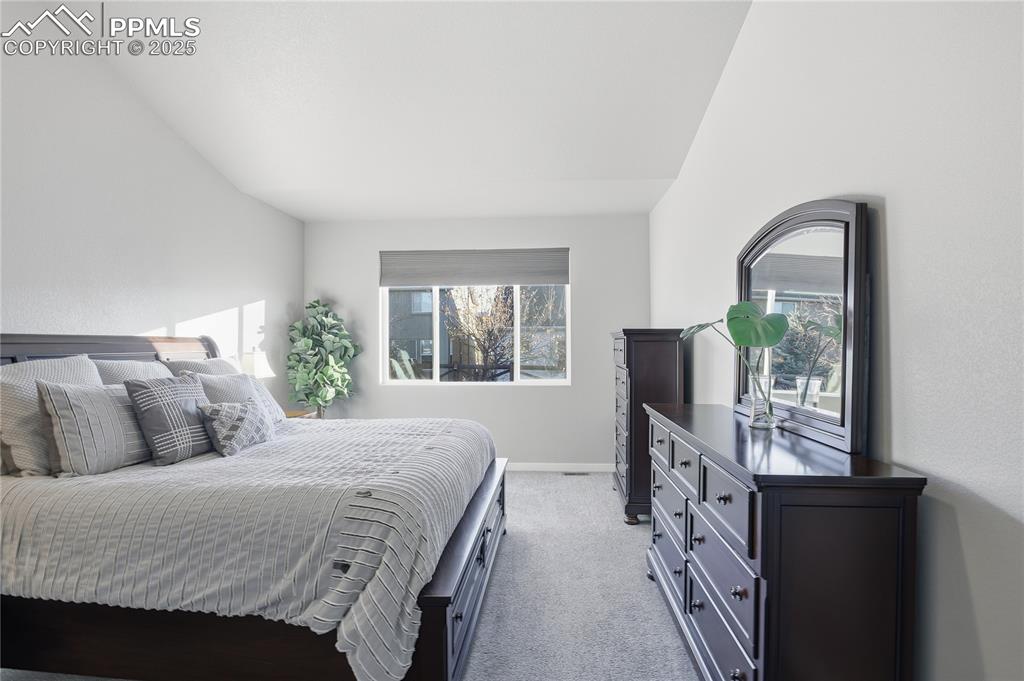 Image 18 of 42: PRIMARY SUITE WITH A WALK-IN SHOWER WITH BENCH, DOUBLE VANITY, AND LARGE WA