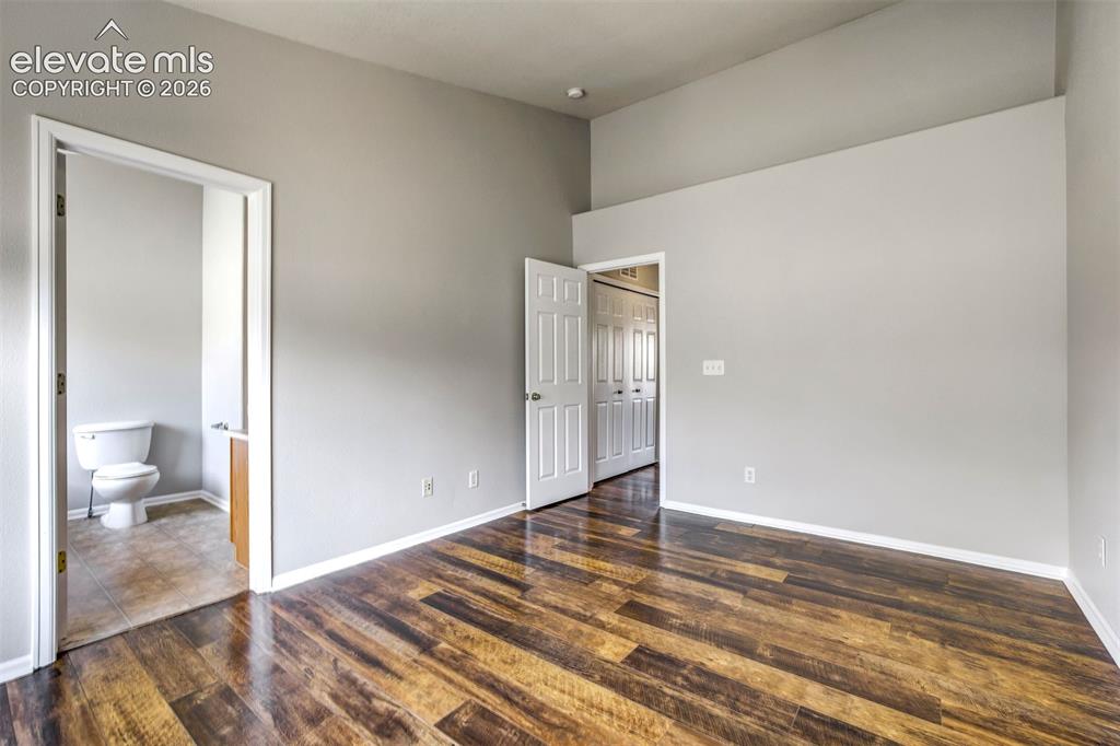 Image 16 of 39: Primary bedroom with vaulted ceilings