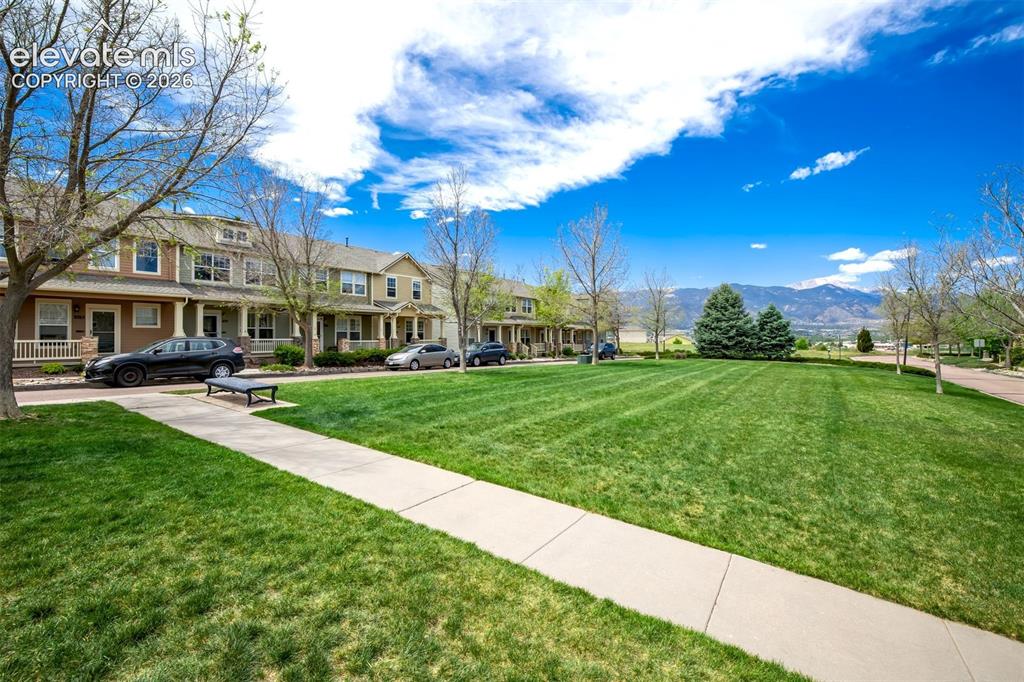Image 2 of 39: One of many green space areas right in front of the property.