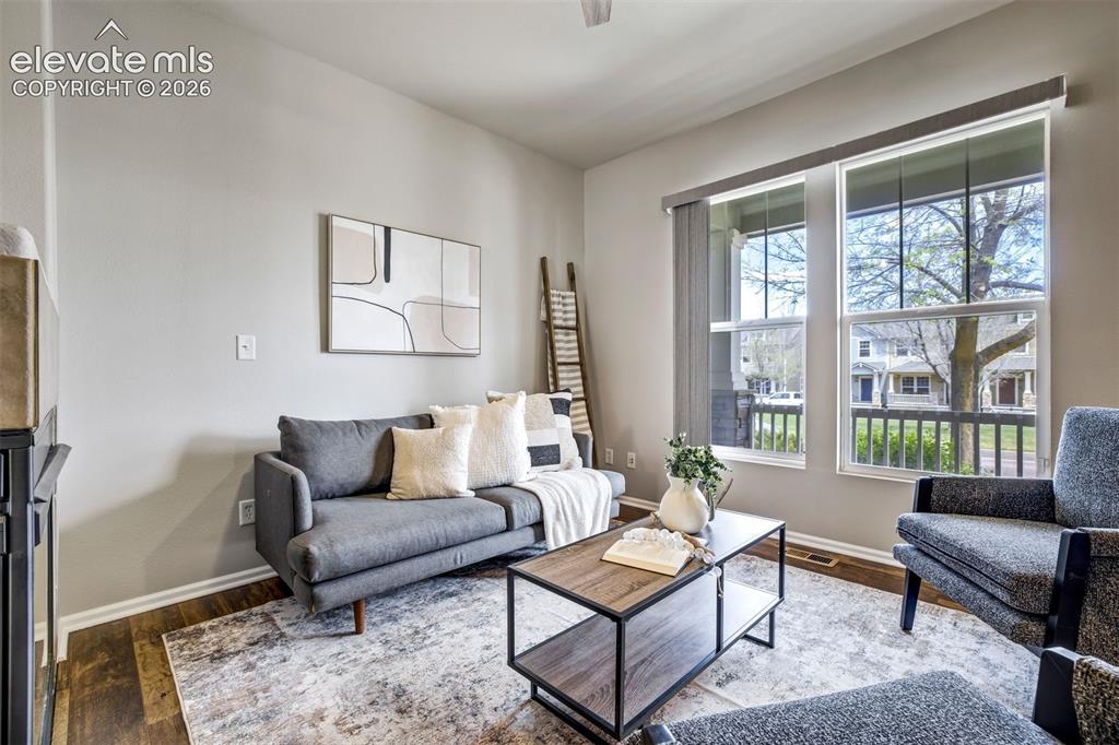 Image 5 of 39: Large living room space with large window that overlooks the covered front 