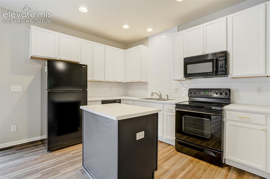 Image 9 of 39: Refreshed kitchen with new counters, new backsplash, new fridge, and new di
