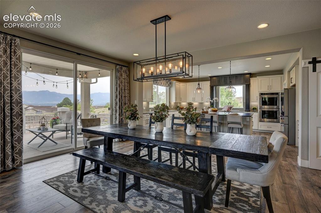 Image 12 of 50: Large dining space in between the living room and kitchen allowing for enjo
