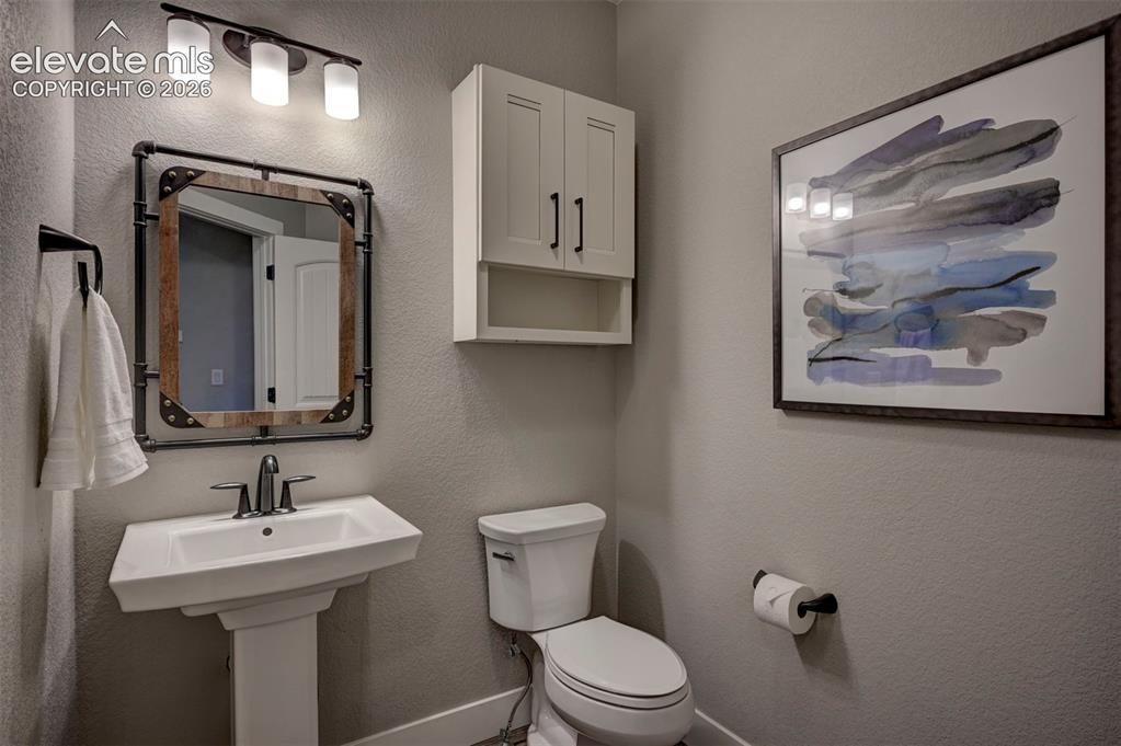 Image 22 of 50: Main Level 1/2 bathroom off the garage entrance and mud room.