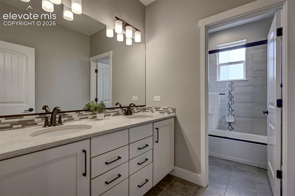 Image 29 of 50: Full Bathroom with double sinks shared by bedroom 2 & 3 upstairs.
