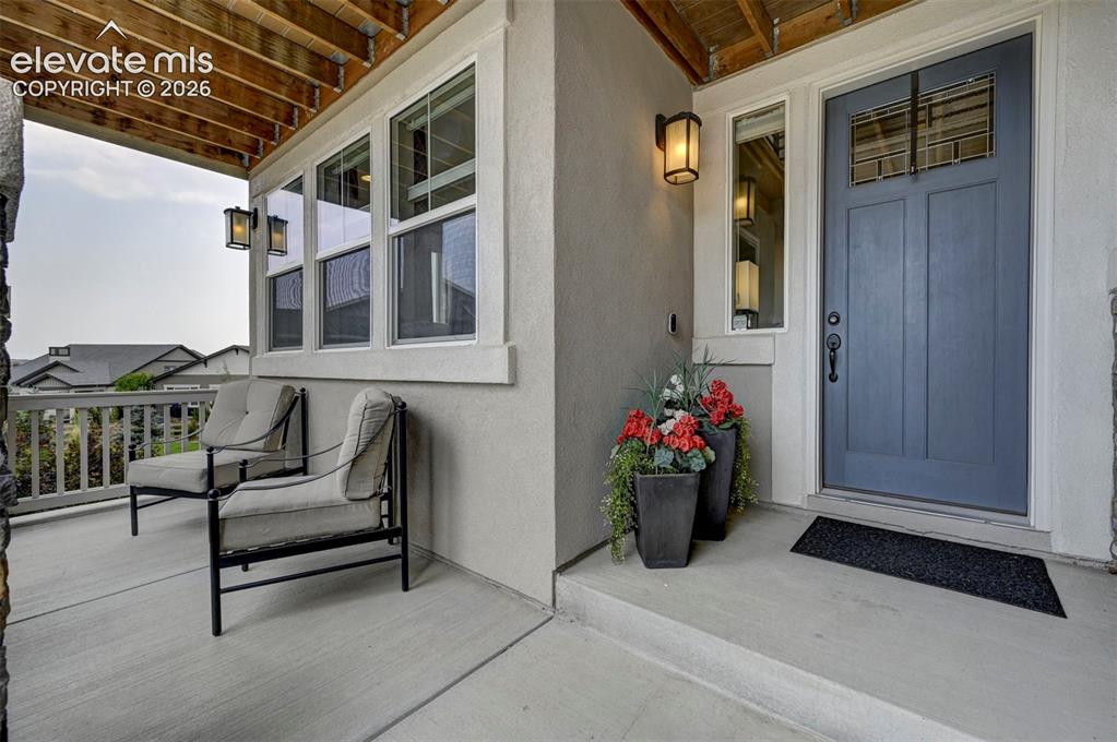 Image 3 of 50: Covered entrance and welcoming balcony.