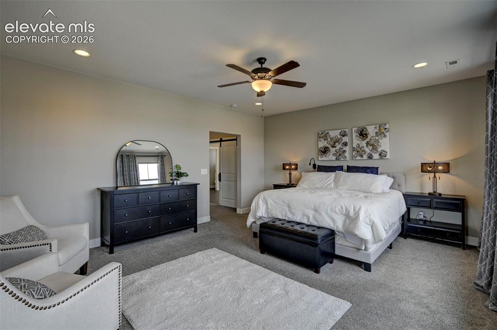 Image 33 of 50: Spacious Primary Bedroom with a walk-out to the covered balcony.