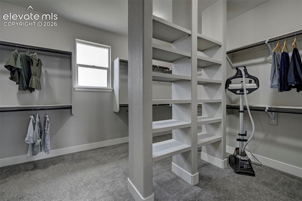 Image 40 of 50: The primary closet is massive with its very own window allowing for natural