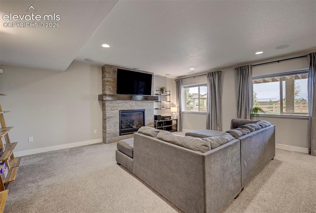 Image 41 of 50: Basement Family Room with Gas Fireplace