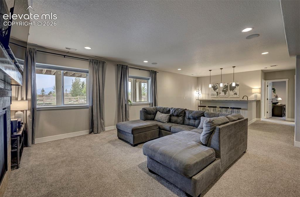 Image 42 of 50: Garden Level Basement with wonderful ambiance and lighting! Even these wind