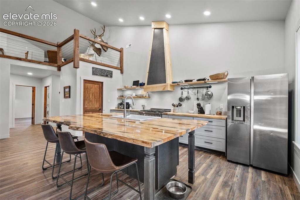 Image 14 of 42: Spacious kitchen featuring an expansive center island, stainless steel appl