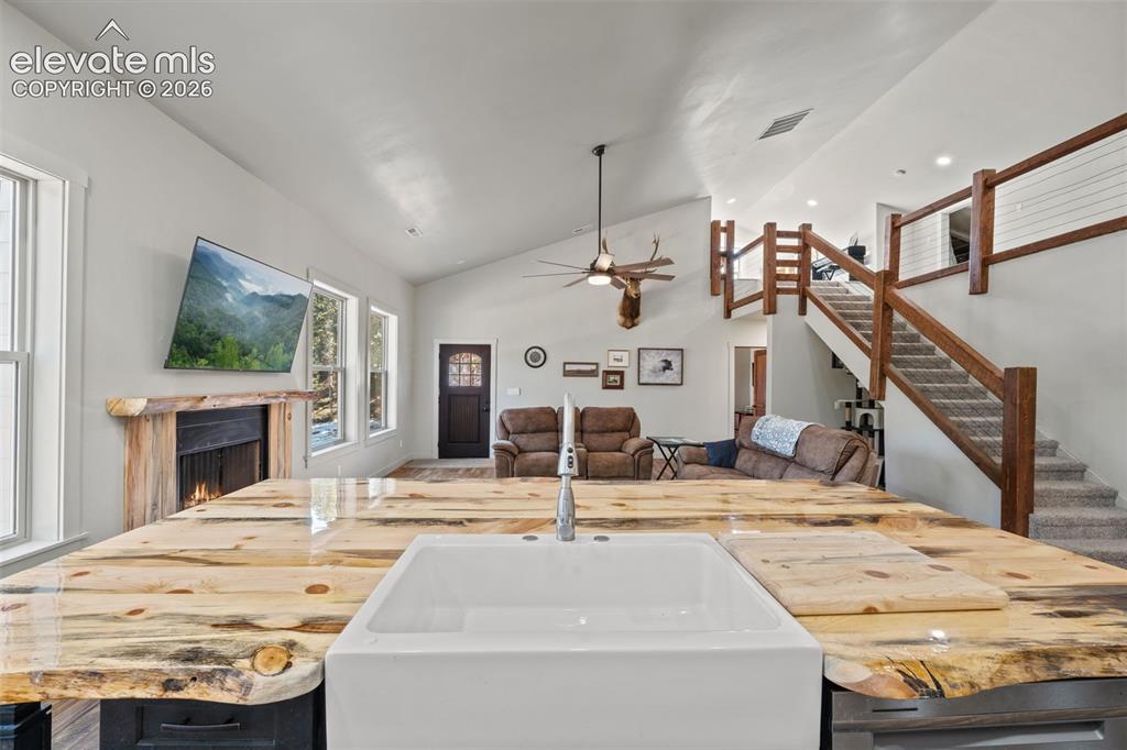 Image 16 of 42: Vaulted ceilings, custom wood-finish island with farmhouse sink, wood-finis