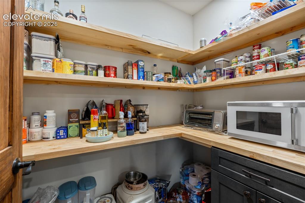Image 18 of 42: Built-in wooden shelving, dark wood-finish door, and integrated lower cabin
