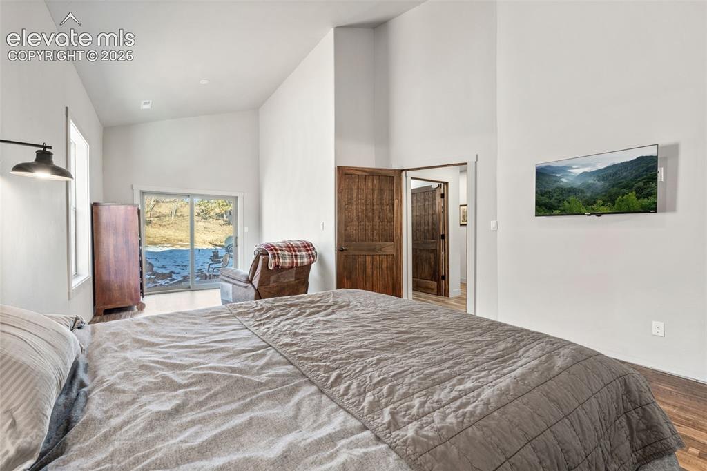Image 21 of 42: Vaulted ceilings, wood-finish flooring, sliding glass door, and solid wood 