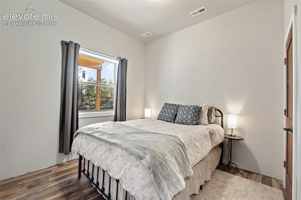 Image 26 of 42: Wood-finish flooring with a neutral wall palette