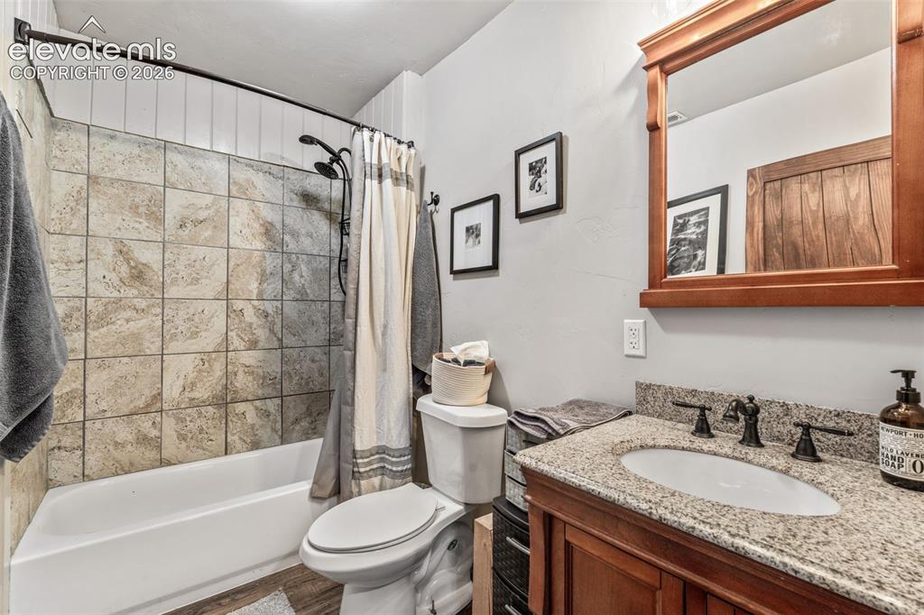 Image 29 of 42: Spa-inspired bathroom featuring a tile-lined shower with glass enclosure an