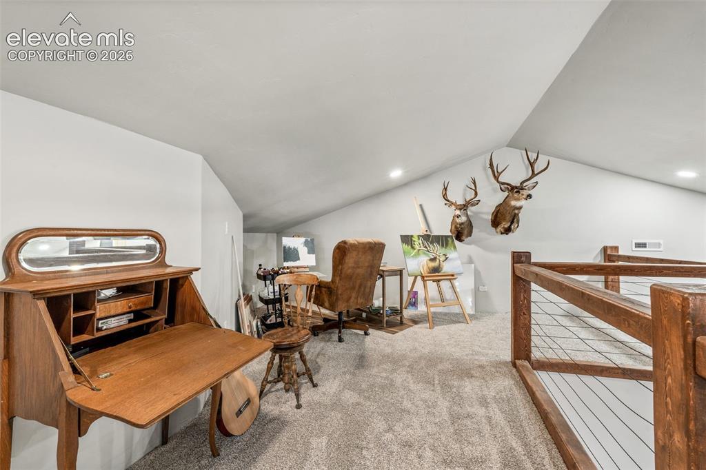 Image 33 of 42: Versatile attic space with vaulted ceilings, recessed lighting, and finishe
