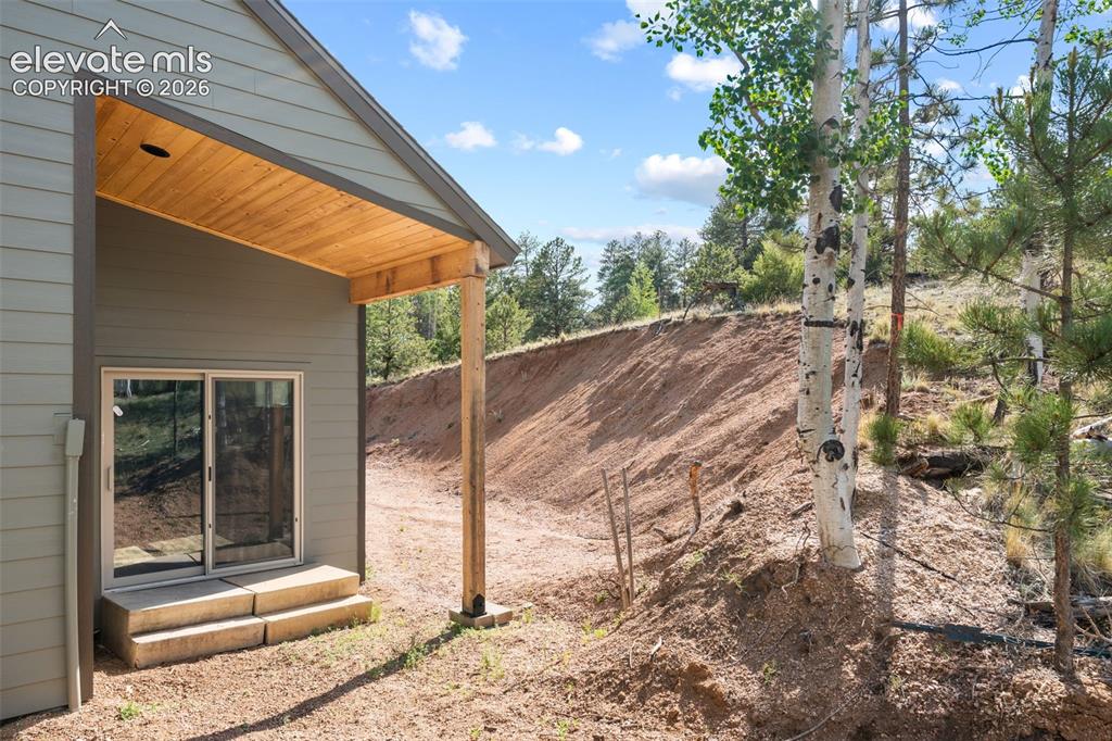 Image 35 of 42: Covered patio with a natural wood-finish ceiling, recessed lighting, and sl