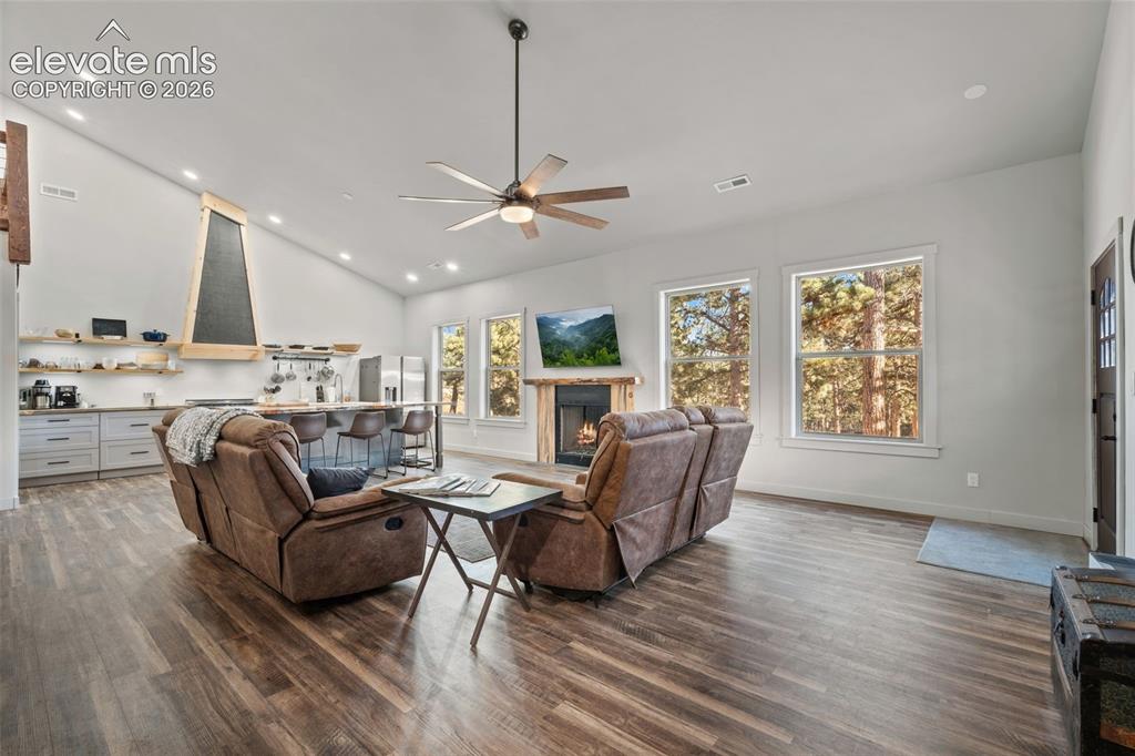 Image 8 of 42: Vaulted ceiling with a ceiling fan, wood-finish flooring, recessed lighting