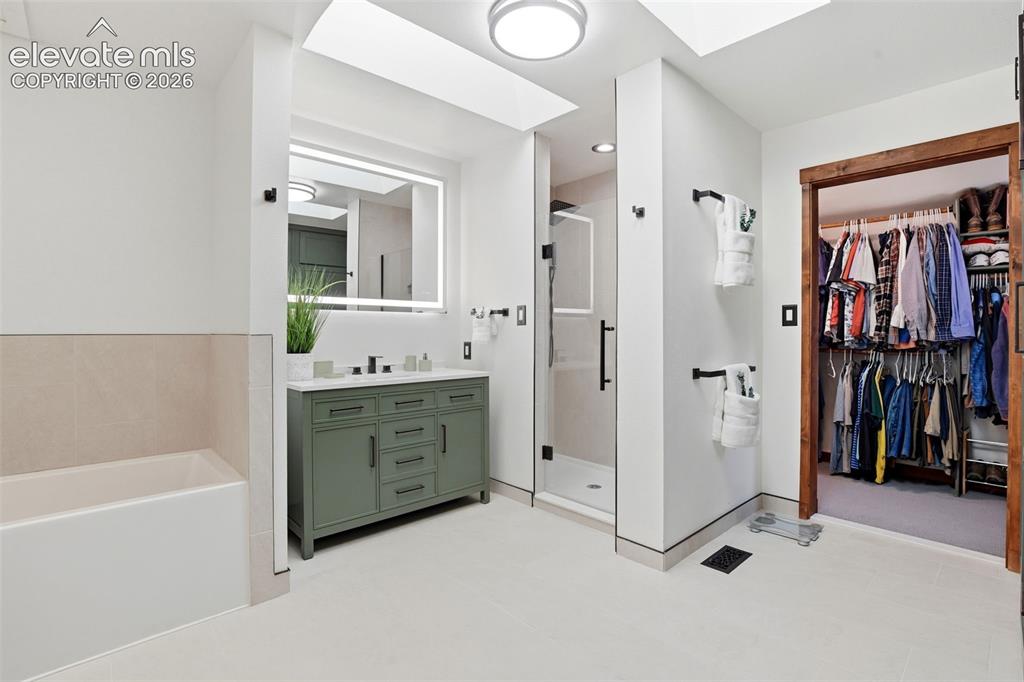 Image 19 of 50: Primary bathroom is a five piece bathroom with a connected walk in closet.