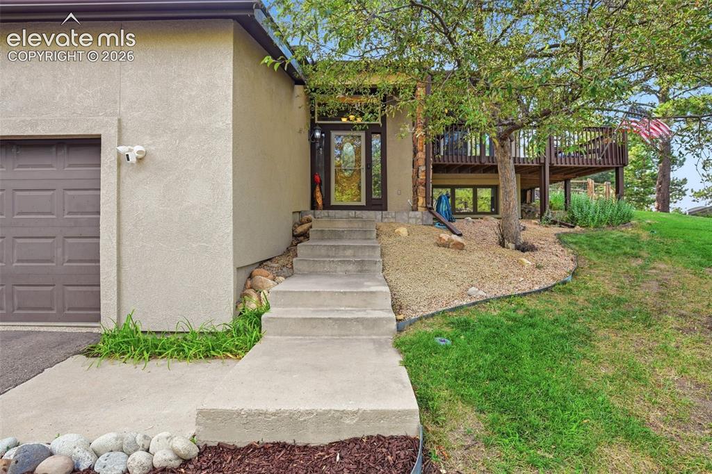 Image 3 of 49: As you enter this home, you walk onto a landing with stairs to the basement