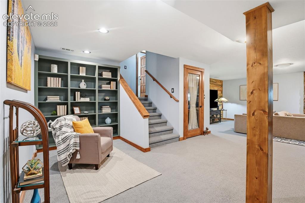 Image 32 of 50: Lovely sitting area with built in shelving.