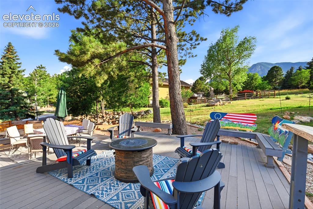 Image 40 of 50: This home has many outside living spaces. This is a deck with built in bar
