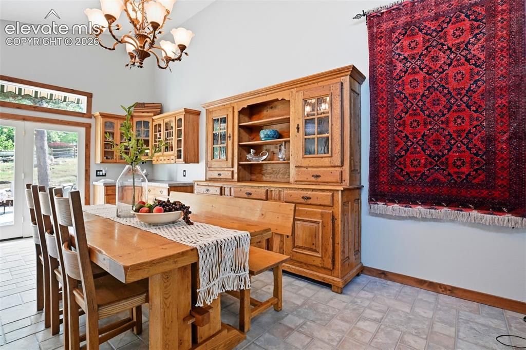 Image 7 of 50: The dinning room area is next to the stairs going to the upper level of the