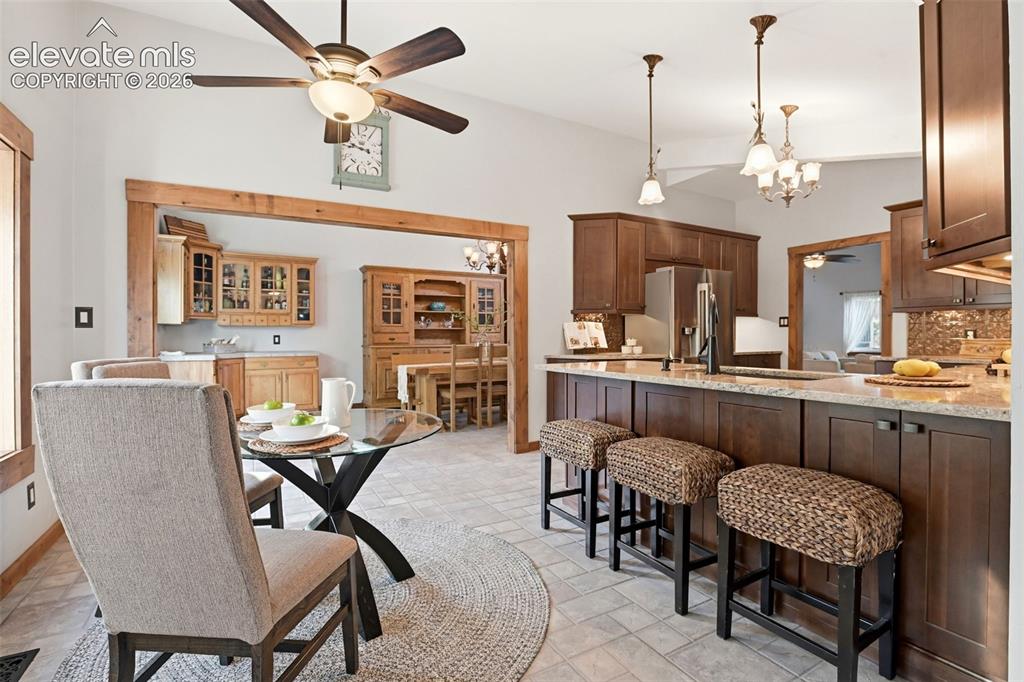 Image 9 of 50: This nook is off the kitchen and allows for bar seating, the pantry and a c