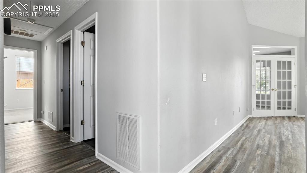 Image 10 of 26: Hallway into the Bedrooms and Bathrooms from the Living Room.