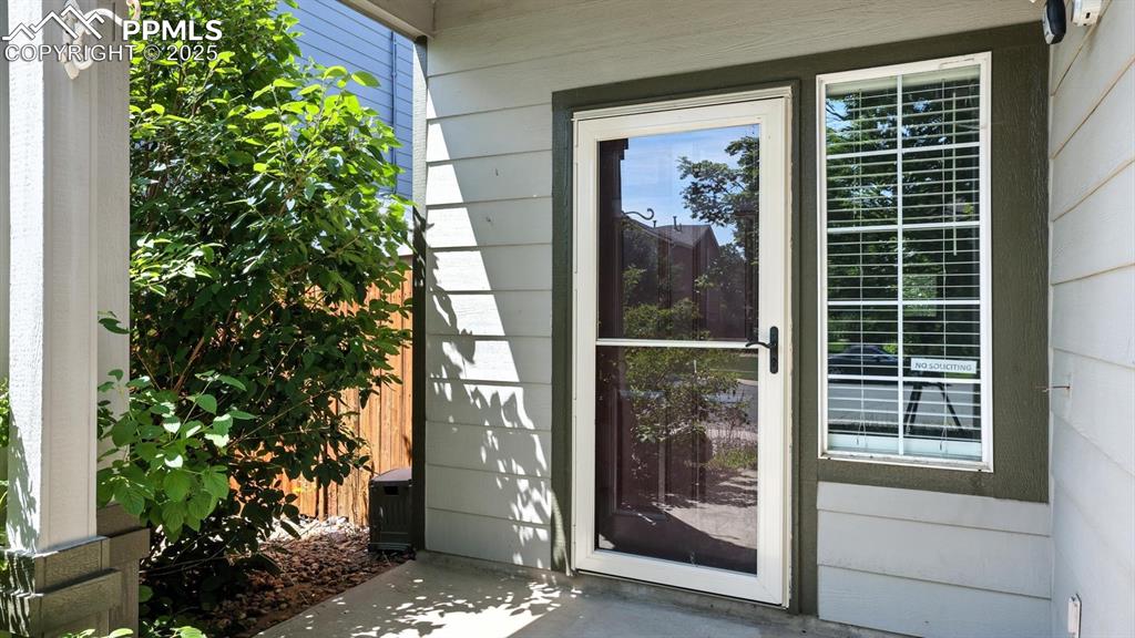Image 2 of 26: Storm door Entry with covered porch.