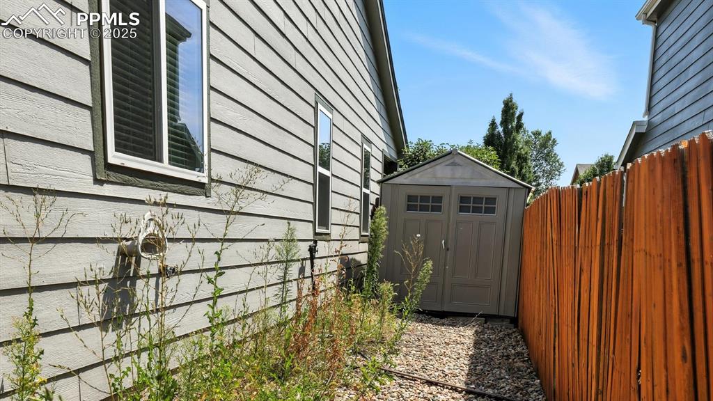 Image 23 of 26: Storage shed for tools and toys.