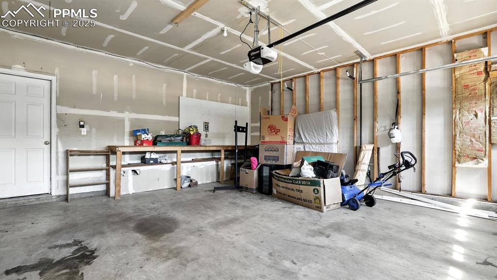 Image 24 of 26: 2-car attached garage with door opener.