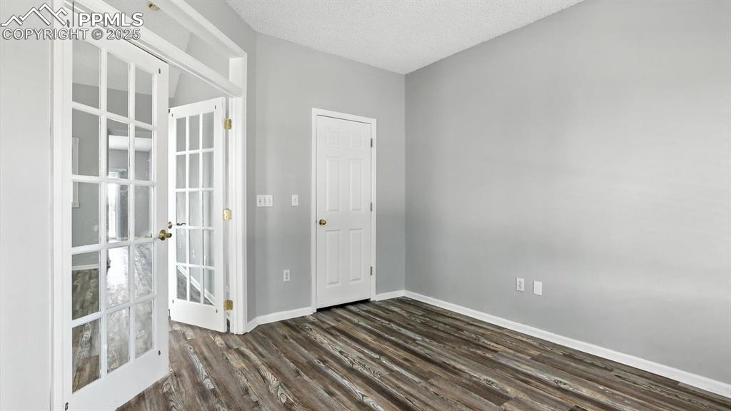 Image 3 of 26: Front Entry into Bedroom #1 with French doors and walk in closet (can also