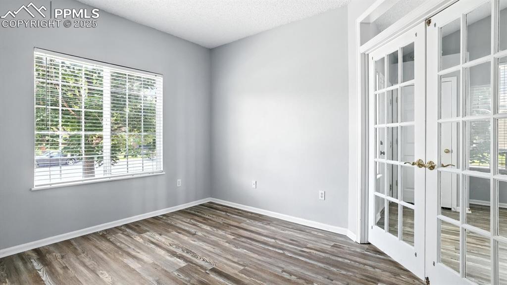 Image 4 of 26: Bedroom #1 (or home office) with LVP floor and walk in closet.