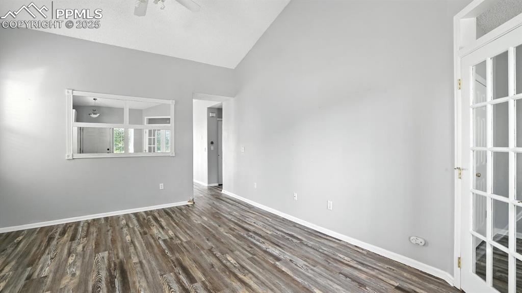 Image 6 of 26: Vaulted Living Room and LVP floor into the Kitchen and Dining Area.