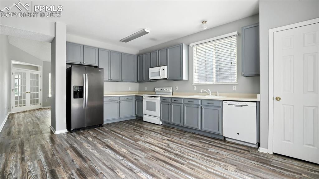 Image 7 of 26: Light and bright Eat-In Kitchen with pantry and tall painted cabinets for k
