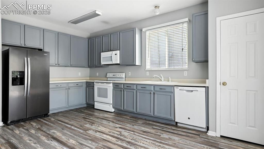 Image 8 of 26: Appliances include a side by side refrigerator, smooth top range oven, buil