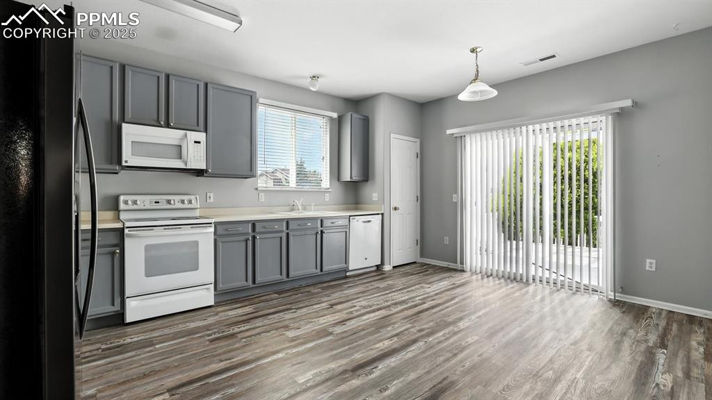 Image 9 of 26: Slider to the backyard deck with partially covered pergola for outdoor dini