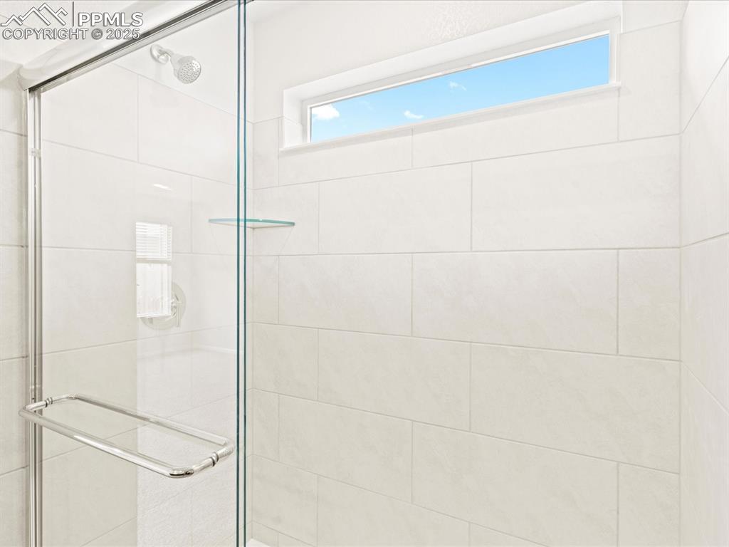 Image 17 of 32: Bathroom with a shower stall