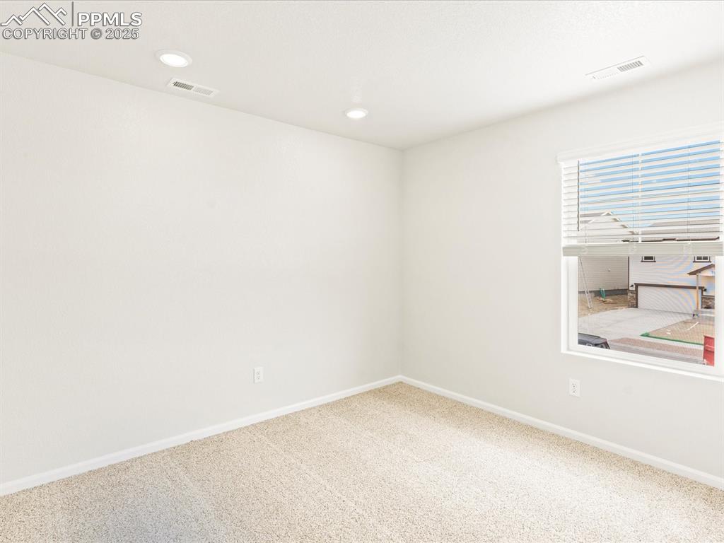 Image 23 of 32: Unfurnished room with carpet flooring and recessed lighting
