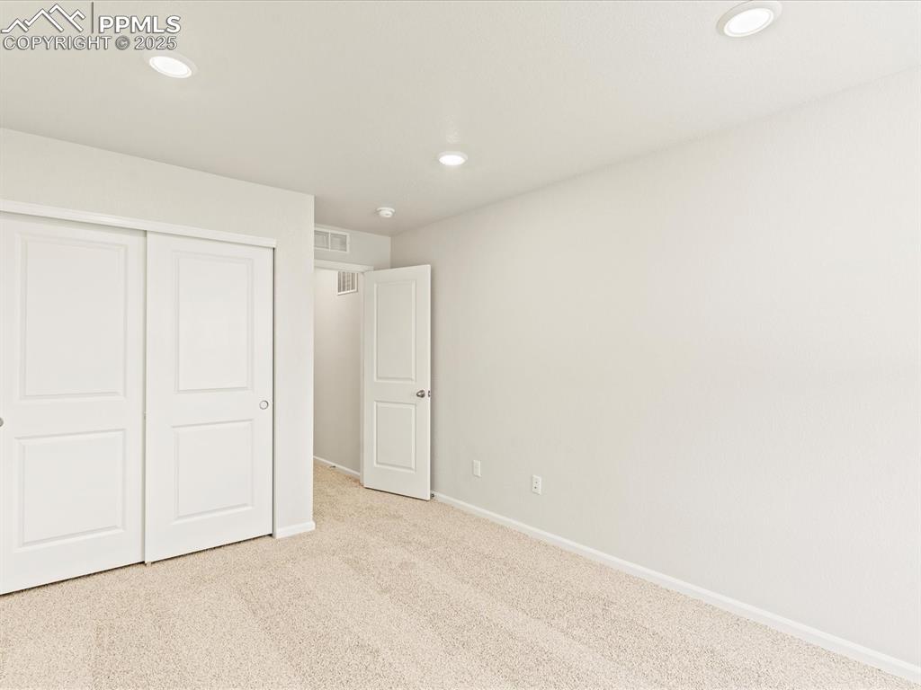 Image 26 of 32: Unfurnished bedroom with carpet flooring, recessed lighting, and a closet