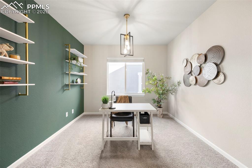 Image 28 of 49: Office featuring baseboards and light carpet