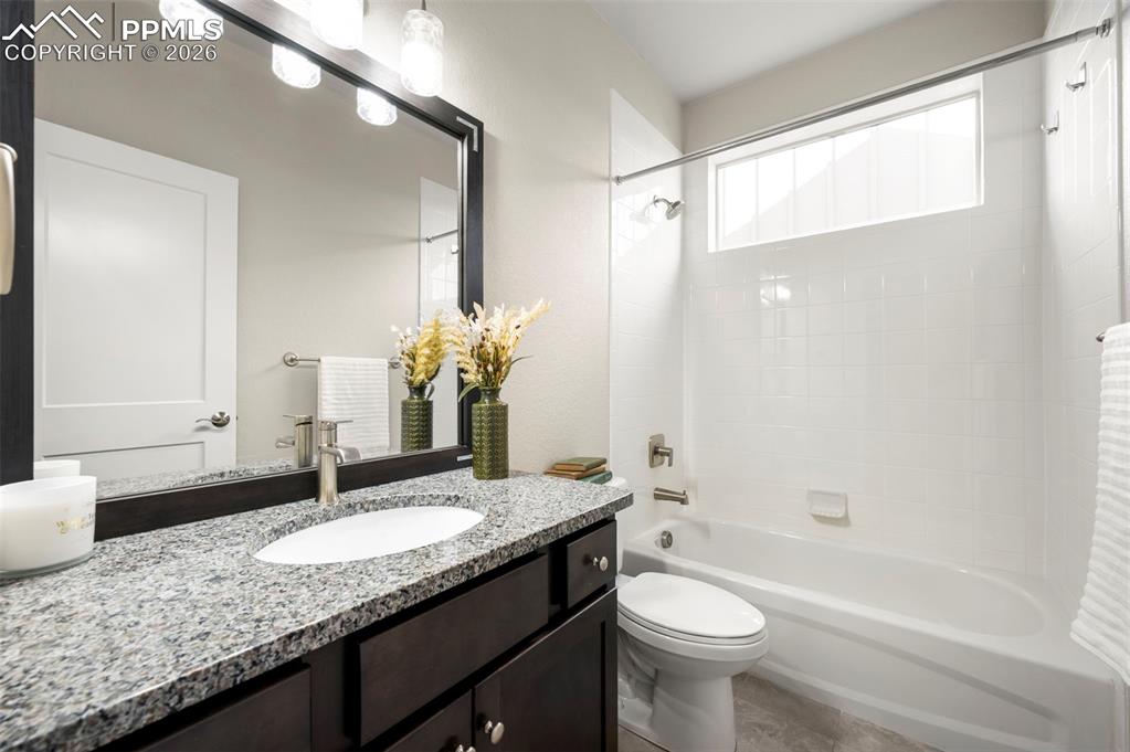 Image 31 of 49: Bathroom with vanity and shower / bathtub combination