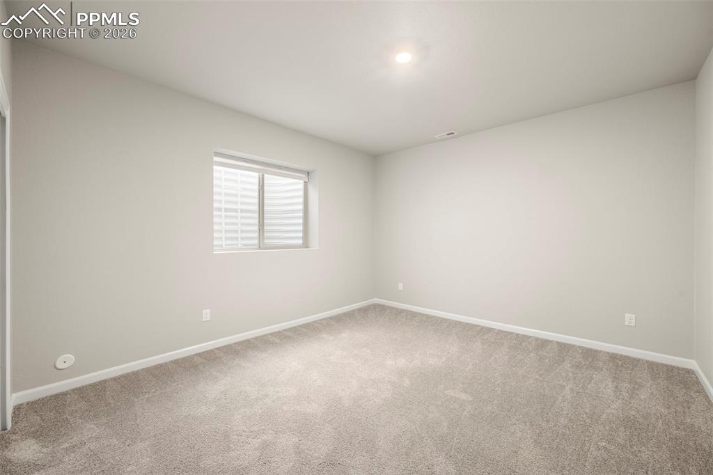 Image 35 of 49: Unfurnished room featuring baseboards and light carpet