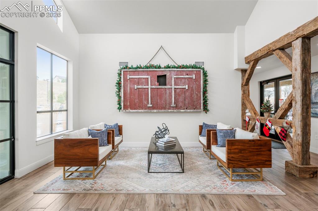 Image 42 of 49: Living area with wood-type flooring and baseboards